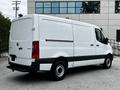 A white 2020 Mercedes-Benz Sprinter van with a high roof and sliding side door parked on a concrete surface