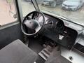 Interior view of a 2012 Ford Econoline with a steering wheel dashboard and control panel showcasing various instruments and buttons