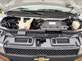 A 2021 Chevrolet Express with its hood open showcasing the engine compartment including various components and fluids