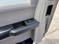 Close-up of the door handle and window control panel of a 2016 Ford F-150 interior