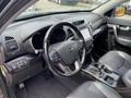 Interior view of a 2015 Kia Sorento featuring a steering wheel dashboard multimedia system and leather seats