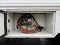 A 2016 International CE300 with visible components including hoses and a junction box in a storage compartment