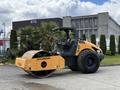 A 2020 Hyundai HR110C road roller with a yellow and black exterior and large rubber tires designed for compacting surfaces
