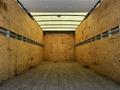 A 2020 Hino 155 truck with an empty wooden cargo area featuring wooden walls and a flat wooden floor