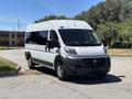 A 2016 RAM Promaster van in white with black accents parked on a lot featuring a large front grill and multiple side windows