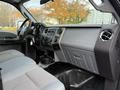 Interior of a 2012 Ford F-550 featuring a dashboard with controls stereo system and seating in a light gray fabric