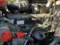 A 2005 Volvo VND 122 engine showing various components including hoses filters and a large air intake system