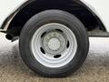 A close-up view of the wheel and tire of a 2012 Ford F-450 SD showing the silver alloy rim and black tire tread
