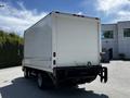 A 2018 Hino 195 box truck viewed from the rear with a white cargo area and black bumper