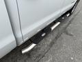 A silver 2016 GMC Sierra 1500 featuring a polished side step with textured black pads for better grip