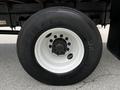 Wheel of a 2020 Hino 338 featuring a black tire with a white rim and eight lug nuts