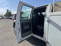 A 2015 Ford F-450 SD with an open driver's side door revealing the interior and seating area