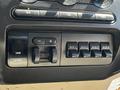 Control panel of a 2008 Ford F-550 featuring buttons for gain adjustment and four auxiliary switches