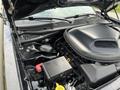 Engine compartment of a 2017 Dodge Challenger showcasing the engine block battery and various components