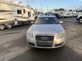 A 2006 Audi A6 in silver with a prominent grille and headlights visible from the front