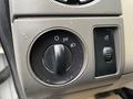 A close-up view of the control panel in a 2010 Ford F-250 SD featuring dials for headlight settings and an additional switch