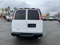 A white 2012 Chevrolet Express van viewed from the rear with tinted windows and no visible license plate