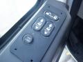 Close-up of a control panel featuring buttons for auto windows locks and door functions in a 2014 International Durastar vehicle