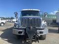 A 2014 International 7400 truck with a bold grille and large headlights positioned head-on with a front-mounted hitch visible