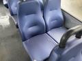 Two blue upholstered seats with a textured surface positioned closely together