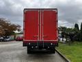 A red 2008 Ford F-750 truck with a large cargo box and double rear doors