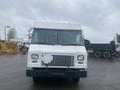 A white 2012 Ford Econoline with a flat front and square design facing the viewer