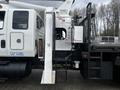 A 2008 International 7500 with a mounted platform lift and utility equipment on the side