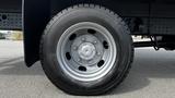 A close-up view of a silver wheel on a 2018 Mitsubishi Fuso FE with a black tire showing the tread pattern and lug nuts