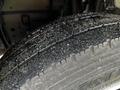 Close-up of a tire from a 2018 Isuzu NRR showing tread patterns and dirt particles on the surface