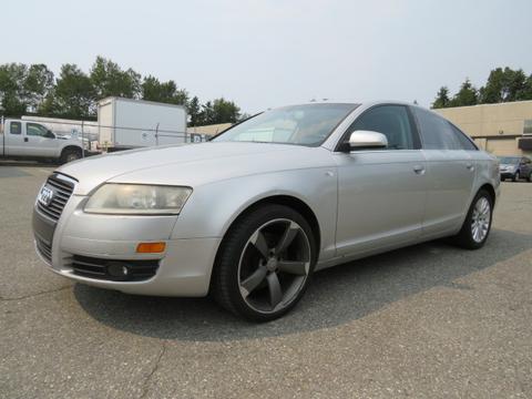 A 2006 Audi A6 in silver with a sleek design and large alloy wheels positioned at an angle highlighting its sporty appearance