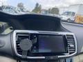 A 2017 Honda Accord Hybrid dashboard featuring a touchscreen display with navigation and audio controls along with a phone mount