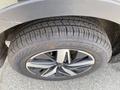 A 2022 Kia Sorento wheel with a dark alloy rim and a tire featuring deep tread patterns