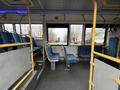 Interior of a 2016 Grande West Vicinity bus featuring blue upholstered seats and yellow handrails with an empty aisle visible in the center