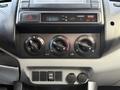 Dashboard controls of a 2013 Toyota Tacoma including temperature settings air conditioning knobs and a clock display