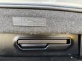 A close-up of a control panel with buttons for adjusting the windows and unlocking doors in a 2004 BMW 6-Series