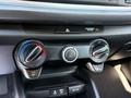 Climate control knobs and air conditioning buttons in a 2018 Kia Rio5 dashboard with a digital display above