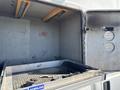 A 2014 Ford F-350 SD truck bed with a metal liner and tiedown anchors visible inside the cargo area