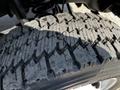 Close-up of a rugged tire from a 2016 Ford F-550 showing deep treads and textured surface designed for off-road performance