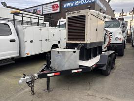 A 2005 Trailerman Generator Trailer with a large generator mounted on top and a metal storage box in front attached to a black trailer with two wheels