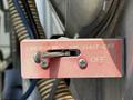 A red emergency air shut-off lever with the words Emergency Air Shut-Off visible, positioned between mechanical components of a 2009 International 7500 truck