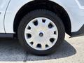 Close-up of a silver wheel on a 2021 Ford Transit Connect featuring a distinctive multi-spoke design and a Bridgestone tire
