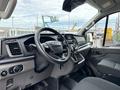 Interior view of a 2023 Ford Transit showing the dashboard steering wheel and controls