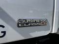 A metallic emblem displaying the text Business Class and M2 attached to a white truck