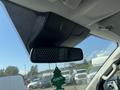 Interior view of a 2016 Ford Transit featuring a rearview mirror with a decorative hanging air freshener shaped like a tree
