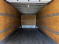 Interior of a 2021 Hino 338 truck showcasing wooden walls and a flat flooring without any cargo present