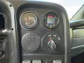Dashboard of a 2009 GMC C5500 featuring gauges for temperature and oil along with a dial for drivetrain settings