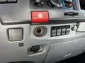 Dashboard control panel of a 2007 GMC W3500 featuring various buttons and a power outlet