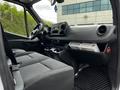 Interior view of a 2020 Mercedes-Benz Sprinter showing the driver’s seat dashboard and center console with storage compartments and controls