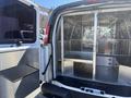 A 2007 Chevrolet Express van with an open rear doors showcasing a metal partitioned cargo area designed for transporting items securely