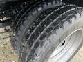 Close-up of the thick, treaded tires of a 2017 Ford F-450 Super Duty showcasing deep grooves for enhanced traction and durability